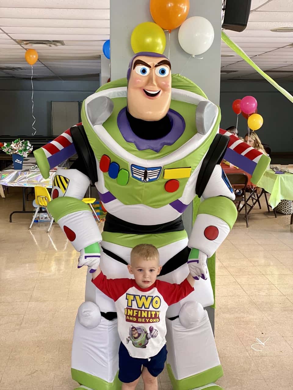 buzz lightyear with boy wearing a white and red shirt