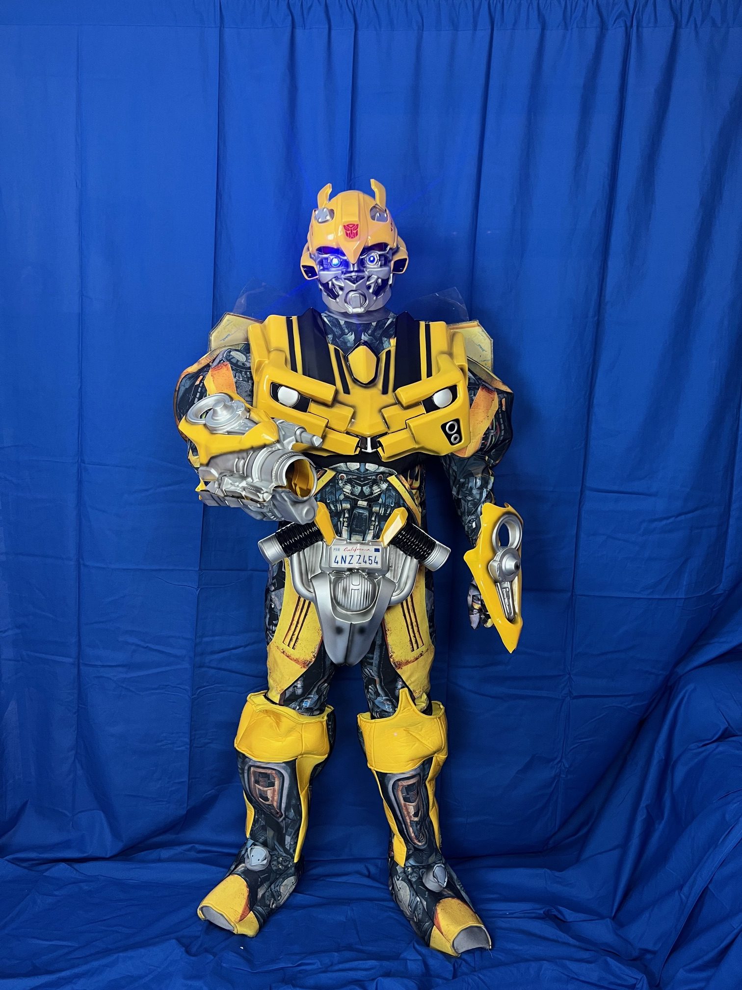 Bumblebee from Transformers standing in front of a blue background | Rent Party Characters
