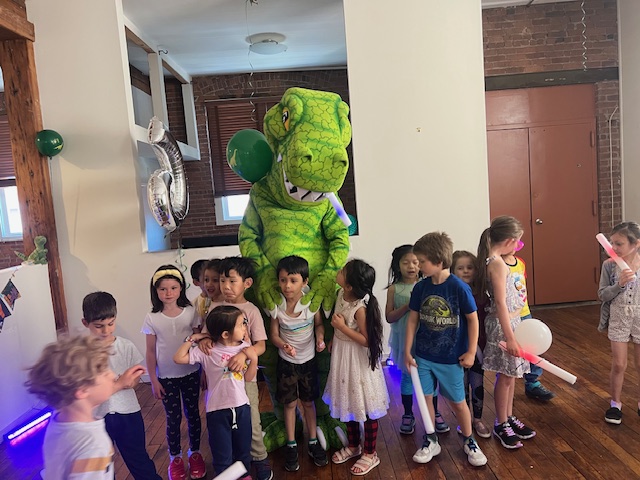 Dino The Dinosaur Tyrannosaurus Rex At Kids Party With Balloons | Rent Party Characters