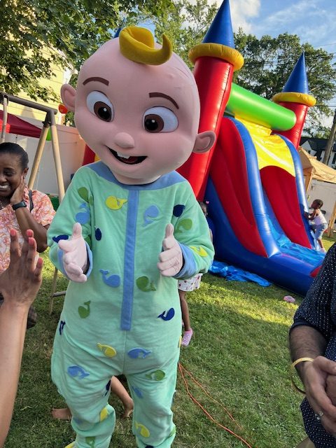 JJ from Cocomelon in front of a bounce house | Rent Party Characters