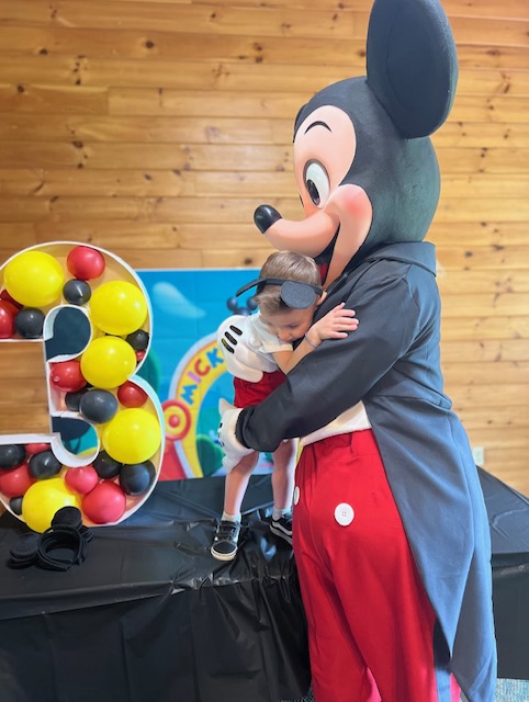 Mickey Mouse Giving A Hug To Kid With Balloons | Rent Party Characters