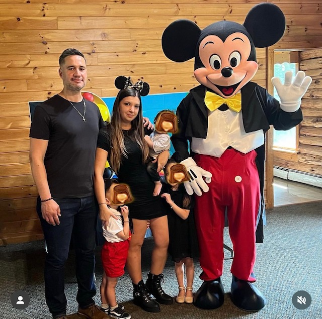 Mickey Mouse waving next to a family | Rent Party Characters