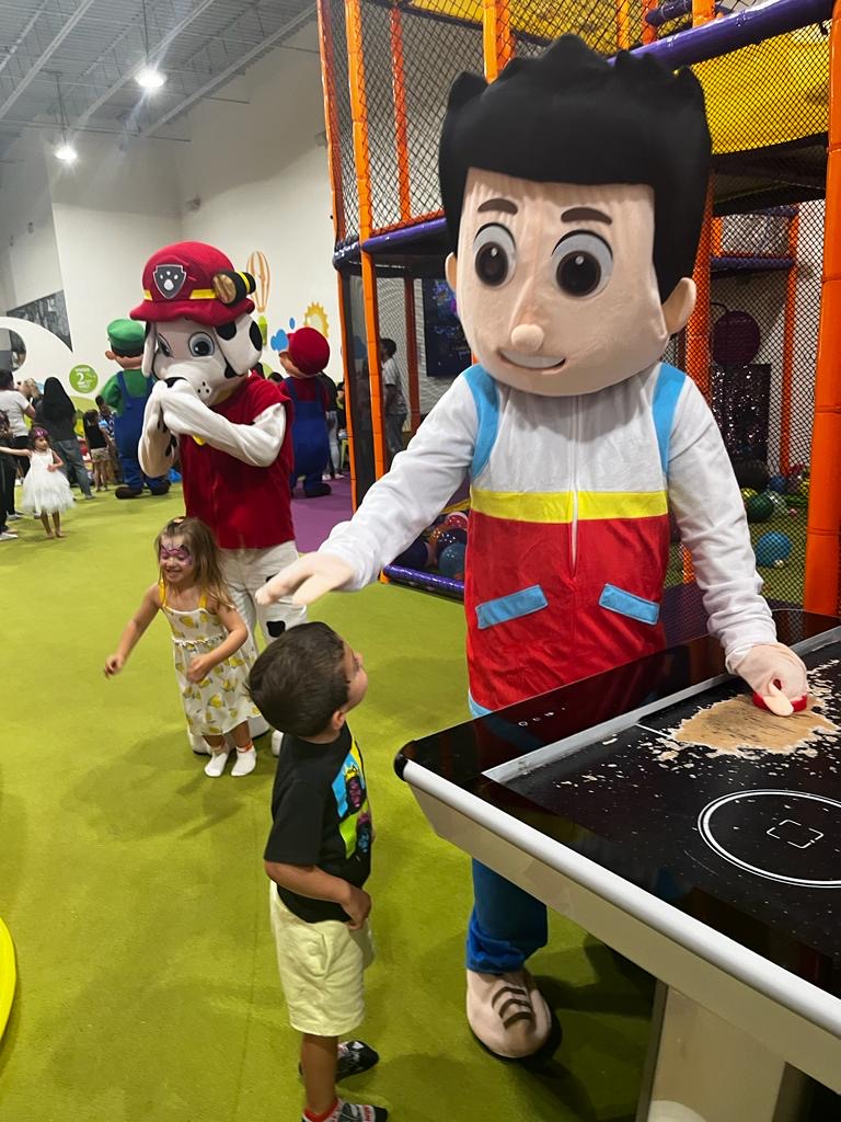 Ryder from Paw Patrol playing air hockey with child | Rent Party Characters