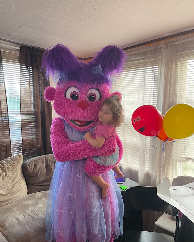 Abby Cadabby hugging girl next to balloons | Rent Party Characters