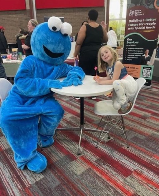 Cookie Monster sitting at a table with girl | Rent Party Characters