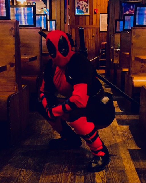 Deadpool posing at a restaurant | Rent Party Characters