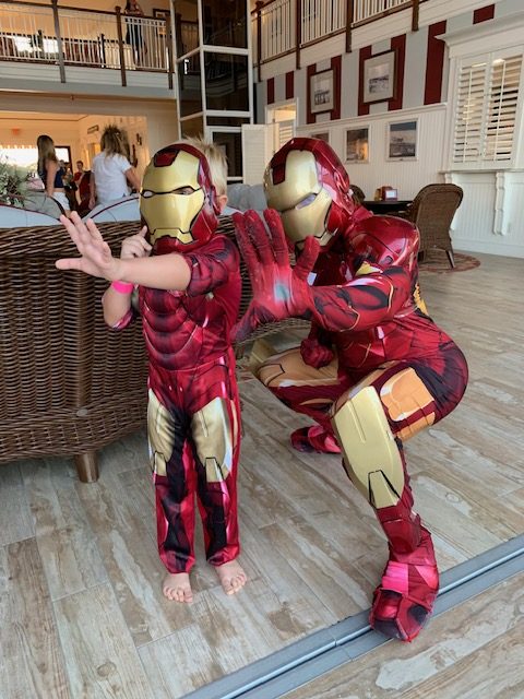 Iron Man with a kid in an Ironman costume doing a hands up pose | Rent Party Characters