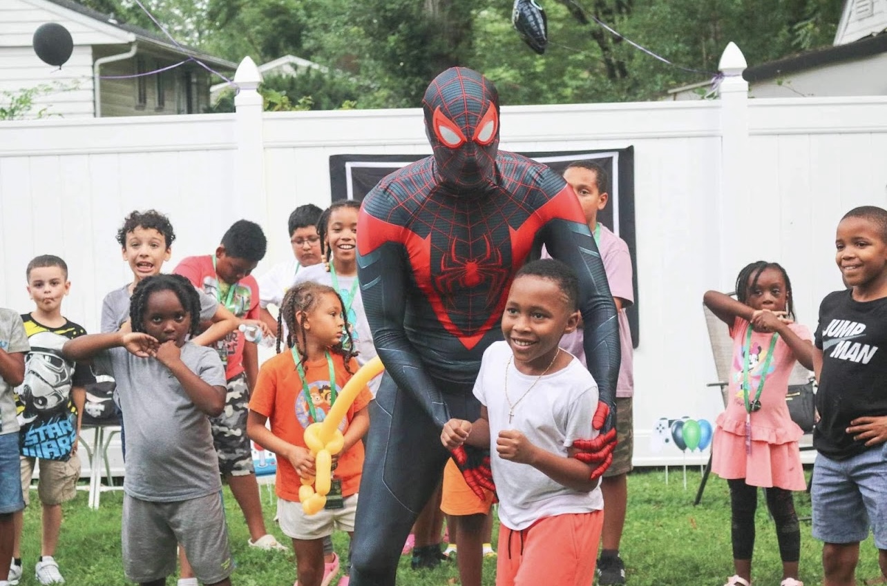 Miles Morales hugging a kid at a party | Rent Party Characters