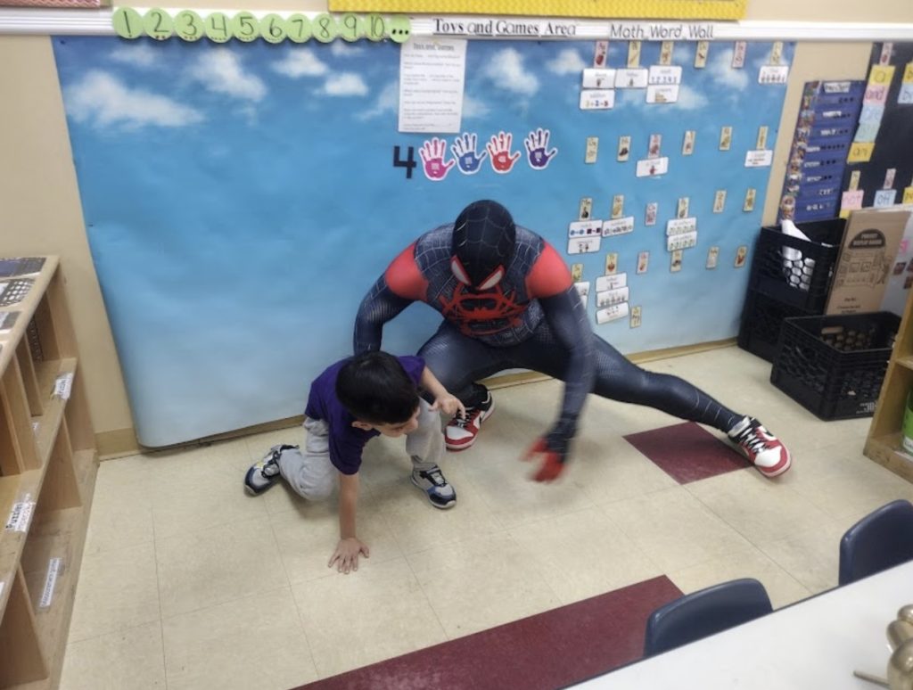 Miles Morales posing in a classroom | Rent Party Characters