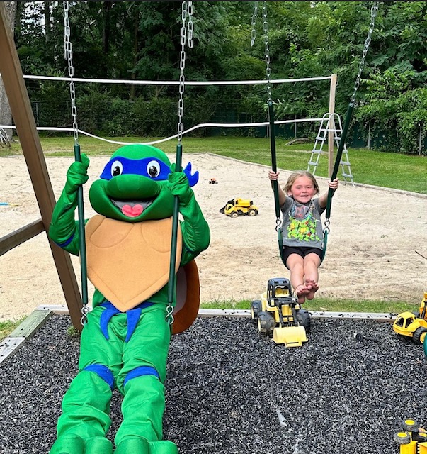 Teenage Mutant Ninja Turtles Leonardo with a kid on the swings | Rent Party Characters