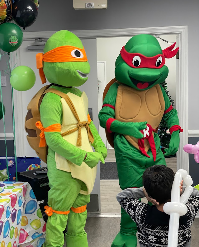 Teenage Mutant Ninja Turtles Raphael and Michelangelo with balloons at a party | Rent Party Characters