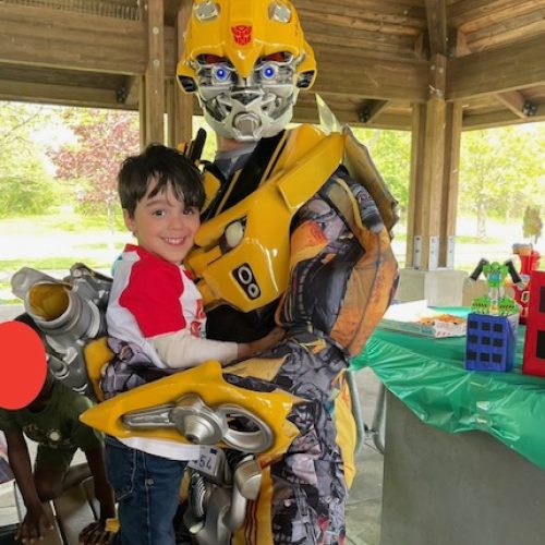 Bumblebee from Transformers hugging a boy at a party Bumblebee from Transformers hugging a boy at a party | Rent Party Characters