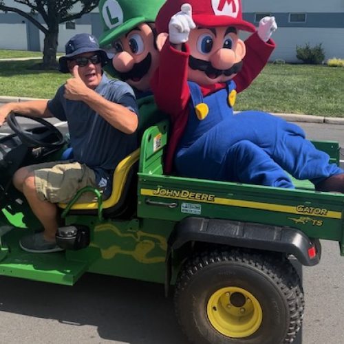 Mario and Luigi on the back of a John Deere truck Mario and Luigi on the back of a John Deere truck | Rent Party Characters